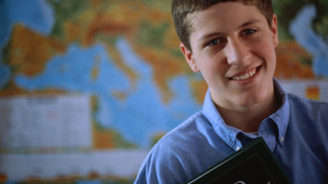 Adolescent Boy Holding a Textbook ca. 2000